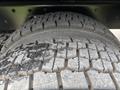 Close-up of two large truck tires from a 2013 Freightliner 114SD showing tread patterns and surface wear