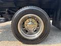Close-up of a shiny chrome wheel and tire on a 2009 Ford F-450 Super Duty showcasing detailed wheel design and tread pattern