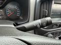 Close-up of a 2017 Chevrolet Colorado steering wheel with a control stalk for windshield wipers and a speedometer visible in the background
