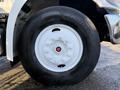 Close-up of a white wheel with a silver hub and red center cap on a 2015 Hino 358 truck tire marked with Hankook brand and model details