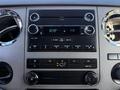 Dashboard of a 2010 Ford F-450 featuring a radio control panel with knobs and buttons for adjusting volume and climate settings