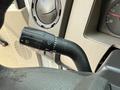 Close-up of the turn signal and windshield wiper control stalk from a 2010 Ford F-550 showing symbols for various functions