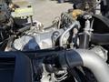Close-up view of the engine compartment of a 2013 International CE300 showcasing various engine components and tubing