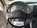 Steering wheel of a 2013 International WorkStar with various gauges and controls visible in the dashboard