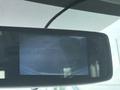 A 2020 Chevrolet Express vehicle interior with a dashboard view featuring a blank screen and control buttons on the side