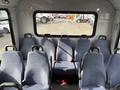 Interior seating area of a 2018 Chevrolet Express with multiple rows of blue fabric seats facing forward