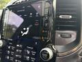 The dashboard display of a 2021 RAM 1500 showing controls for climate settings heated and vented seats along with audio and navigation options