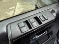 Close-up of the window control panel in a 2021 Toyota 4Runner featuring buttons for window operation and door locks