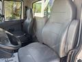 Interior of a 2013 International 7500 featuring two gray leather seats positioned in the cab with seatbelt fittings visible