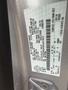 A label on a 2014 Ford Escape containing vehicle information including the VIN, weight limits, and manufacturing details