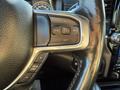 Close-up of a steering wheel with buttons for cruise control and gear limit on a 2023 RAM 3500