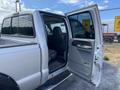 A silver 2007 Ford F-350 SD with an open driver's side door and a view of the interior seats and dashboard visible inside the cab