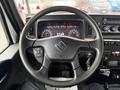 Steering wheel of a 2020 International MV607 with control buttons and a dashboard displaying gauges and dials