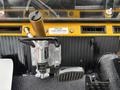 Control panel of a 2004 Bombardier SW48 featuring a gear shifter and foot pedal with labels and switches visible on a textured black surface