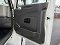 The interior door panel of a 2011 International 4400 featuring a molded design with an armrest and a handle for opening