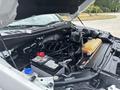 A 2017 Ford F-150 engine bay showing the engine components battery and coolant reservoir in a clean and organized layout