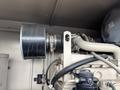A 2005 Katolight SED60FPJ4 generator featuring a large black exhaust pipe connected to the engine with various hoses and fittings
