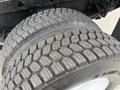 Close-up of a set of tires from a 2006 International 4200 showing substantial tread depth and wear patterns on the rubber surface