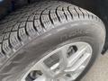 A close-up view of a Nokian winter tire mounted on a silver alloy wheel of a 2022 Chevrolet Equinox
