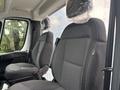 Interior view of a 2023 RAM Promaster 3500 showing two front seats with protective coverings on the headrests