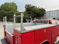 A red 2015 Chevrolet Silverado 3500HD pickup truck with a metal flatbed featuring tool compartments and side rails