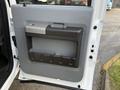 The image shows the interior door panel of a 2015 Ford F-550 featuring a large gray storage pocket and a metallic handle