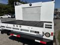 A 2017 Ford F-550 with a flatbed design featuring a textured surface and multiple rear lights