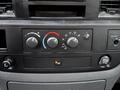Control panel of a 2008 Sterling Bullet with temperature and airflow dials along with a power outlet and button for additional features