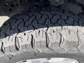 Close-up of the tread on a tire from a 2018 Ford F-150 showcasing deep grooves and patterns designed for traction