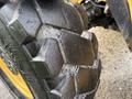 Close-up of a worn tire on a 2014 Caterpillar TL1055C showing deep treads and some visible wear spots
