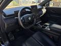 Interior of a 2023 Fisker Ocean featuring a modern dashboard a large touchscreen display and leather seats