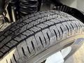 Close-up view of a tire from a 2023 Ford E-450 showing detailed tread patterns and textures