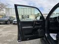 A 2021 Toyota 4Runner with the driver's side door open showcasing the interior features and controls