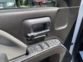 The interior door handle and control panel for windows of a 2020 Chevrolet Silverado