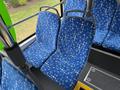 Two blue patterned bus seats with armrests inside a 2018 Grande West Vicinity bus