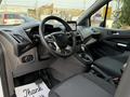 Interior of a 2019 Ford Transit Connect featuring a steering wheel dashboard and front seats with a modern design and tech interface