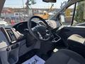 Interior view of a 2019 Ford Transit 350 showcasing the steering wheel dashboard and front seats