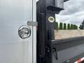 2015 Mitsubishi Fuso FE160 with a silver body featuring a side door handle and a rope secured to the truck bed