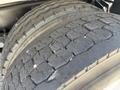 Close-up of the worn tires on a 2015 Ford F-750 showing significant tread wear and cracks on the rubber surface