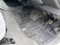 Interior floor area of a 2009 Toyota Hiace showing carpet mats pedals and floor controls