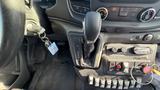 Interior view of a 2021 Ford Transit showing the gear shift lever ignition key and various control buttons on the console