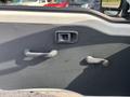 Interior door panel of a 2010 Daihatsu Hijet featuring a door handle a window crank and a small square window control