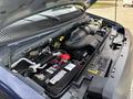 The engine compartment of a 2013 Ford E-350 Super Duty showing the battery air intake and various engine components