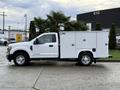 A white 2017 Ford F-350 SD utility truck with a side service body and a single cab design