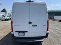 A 2022 Mercedes-Benz Sprinter van viewed from the rear with a white exterior and the logo prominently displayed on the back door