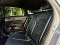 Interior view of the backseat of a 2024 Kia Forte5 featuring black leather seats with a sleek design and ample legroom