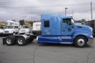 A blue 2015 Kenworth T660 truck is shown with a streamlined design and prominent front grille featuring a logo on the side