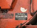 A metal identification plate featuring the model and serial numbers for a 2015 Kubota F3990 machinery unit