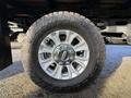 Close-up of a silver alloy wheel with a rugged tire on a 2020 Ford F-350