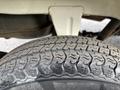 Close-up of a tire from a 2010 Daihatsu Hijet showing detailed tread pattern and sidewall design